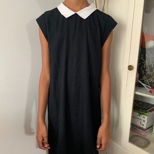 Black sleeveless dress with white collar